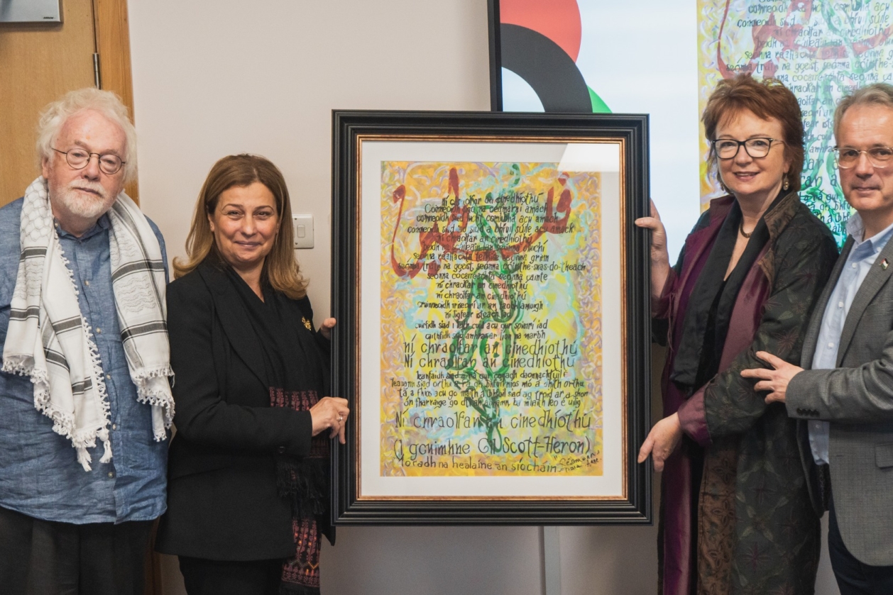 Dara Valelly, Anne Hart and Réamonn Ó Ciaráin present a bespoke piece of art to Dr Wahba Abdalmajid, ambassador to Palestine.