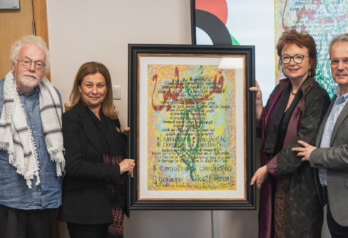 Dara Valelly, Anne Hart and Réamonn Ó Ciaráin present a bespoke piece of art to Dr Wahba Abdalmajid, ambassador to Palestine.